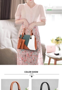 Close-up of color-block leather tote bag with stylish gold hardware and hanging mini pouch