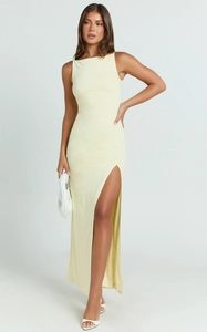 Detail view of a pale yellow sleeveless maxi dress featuring a high side slit and slim fit