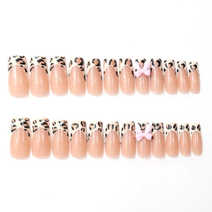 French tip press-on nails with leopard print patterns and pink 3D ribbon bows