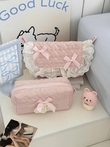 Detail of pink quilted cosmetic bags with heart texture, lace edges and ribbon bows