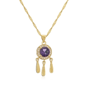 Close-up of golden dreamcatcher necklace with purple gemstone and feather pendants