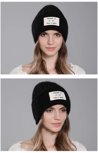 Detailed views of black fuzzy rabbit hair beanie with a white lettered fabric patch