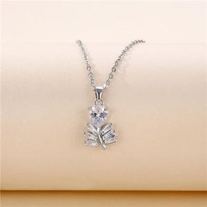 Silver leaf pendant necklace with shimmering cubic zirconia stones on soft background