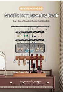 Close-up of black iron jewelry organizer with wooden base on a vanity table
