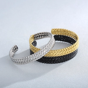 Detail of 9mm wheat pattern open bangles in gold, silver, and black stainless steel