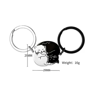 Close-up of black and white cat couple keychains with 16g weight and 25x29mm size