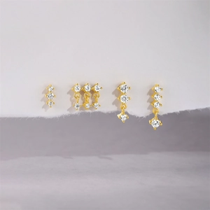 Detailed macro view of gold-plated silver earrings set with sparkling zirconia accents