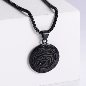 Vintage 18K gold plated Horus Eye pendant with black chain on white platform