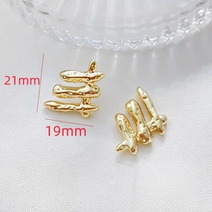 Detailed close-up of 14k gold plated irregular coral-shaped earrings with size markings