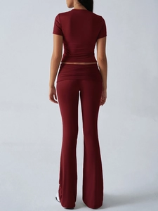 Rear view of deep red short sleeve crop top and flared pants set with folded waist