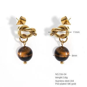 Detail showing 18K gold-plated butterfly knot earrings with 8mm brown natural stone beads