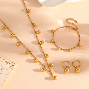Elegant gold stainless steel jewelry set featuring bead charm necklace, bracelet and earrings