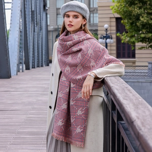 Chic houndstooth scarf with red, blue, and beige patterns on a female model outdoors