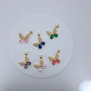 Macro shot of 6 colorful butterfly pendants with gold plating and sparkling gemstones