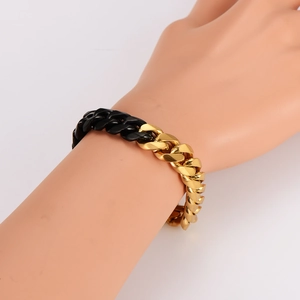 Two-tone gold and black stainless steel Cuban link bracelet for men on wrist display