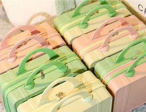 Detailed view of colorful 14-inch mini suitcases with textured shells and dual zippers
