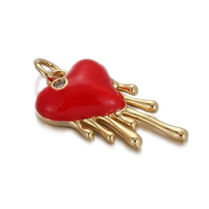 Detailed close-up of a red melting heart pendant with a crystal gemstone on a gold base