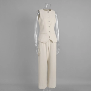 Detail of cream vest suit with round neck, decorative buttons and high waist straight pants