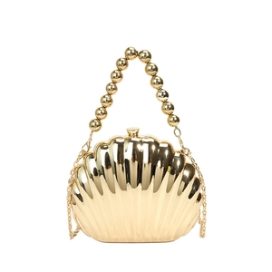 Elegant gold shell evening clutch bag with beaded handle and chain strap on white background