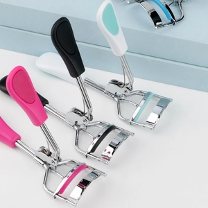 Portable stainless steel mini eyelash curlers in pink, black, and mint green colors
