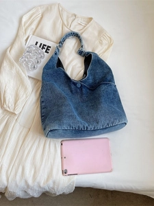 Minimalist large capacity blue denim tote bag for women with woven strap on white fabric