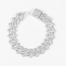 Macro detail of silver iced out Cuban link bracelet with sparkling rhinestones and clasp