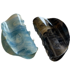 Artistic marble blue and amber brown acetate hair claw clips on white background