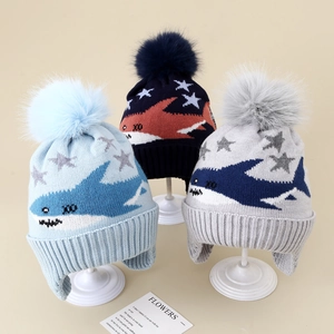 Winter knit earflap hat for boys with cartoon shark jacquard and large fluffy pom-poms