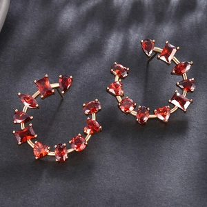 Elegant C-shaped golden earrings featuring colorful irregular cubic zirconia gemstones