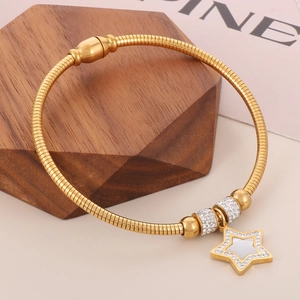 Close-up of gold snake texture bracelet with star pendant and pavé diamond beads