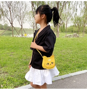 Close-up of yellow cartoon cat crossbody bag for kids featuring a sleek PU leather finish