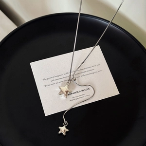 Minimalist silver star pendant necklace with delicate snake chain in a stylish Y-shape
