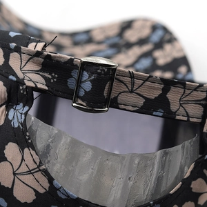 Detailed macro of the adjustable fabric strap and silver buckle on floral baseball cap