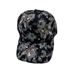 Close-up of butterfly rhinestone design and floral patterns on black baseball cap