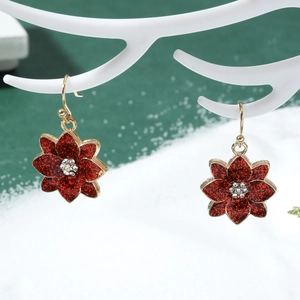 Detail of red flower drop earrings with glitter and crystals on white festive antlers