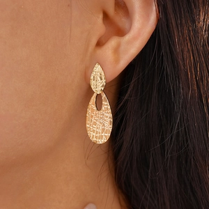 Textured golden double teardrop earrings with elegant hammered metallic finish