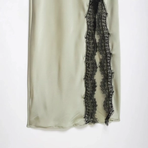 Light green satin slip dress featuring elegant black eyelash lace trim and slit detailing