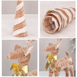 Detail of champagne velvet Christmas tree and reindeer ornament with golden bow