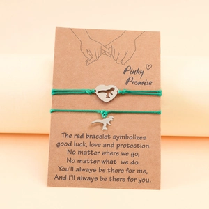 Couples heart dinosaur braided rope bracelets with Pinky Promise card on orange background