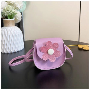 Detail of purple PU leather mini crossbody bag with a large pink sequin flower accent