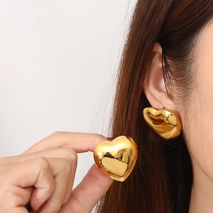 Chic large 18K gold plated hollow heart-shaped stud earrings shown on model profile