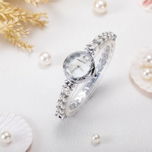Detail of silver ladies quartz watch with pearl bracelet and white mother of pearl dial