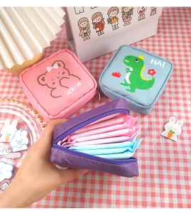 Detailed view of open fabric sanitary napkin pouch showing large storage capacity