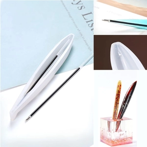 Detailed view of DIY resin pen silicone mold with black ink refill and gold foil filler