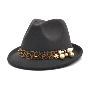 Detail of grey wool felt fedora featuring leopard ribbon with pearls and gold floral ornament