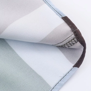 Macro detail of striped satin shirt fabric showing fine texture and quality stitching