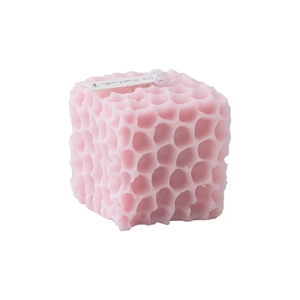 Pink square scented candle with honeycomb texture and decorative label on white background