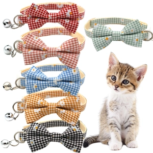Macro shot of colorful daisy plaid collars with bows and bells for cats and puppies