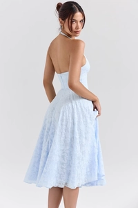 Detail view showing the textured fabric and open back of light blue halter midi dress