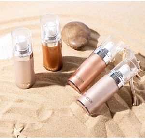 Detailed view of four liquid highlighters in bronze and gold tones on a sunny beach